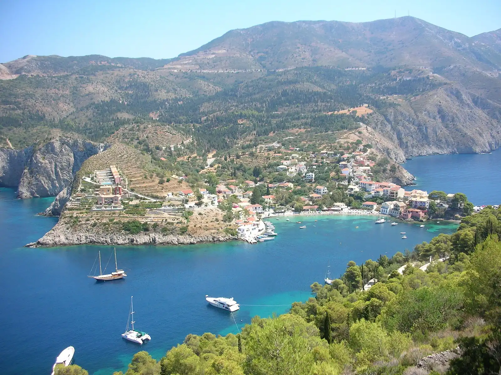 Overhead view of Assos village and bay between green hills