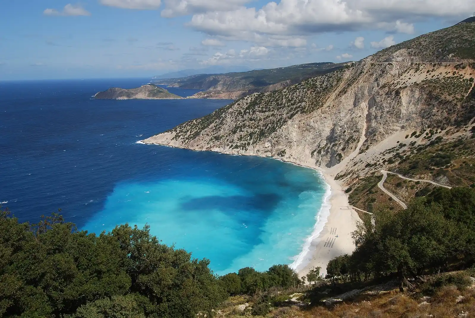 White pebble beach and turquoise water below cliffs at Myrtos, Kefalonia