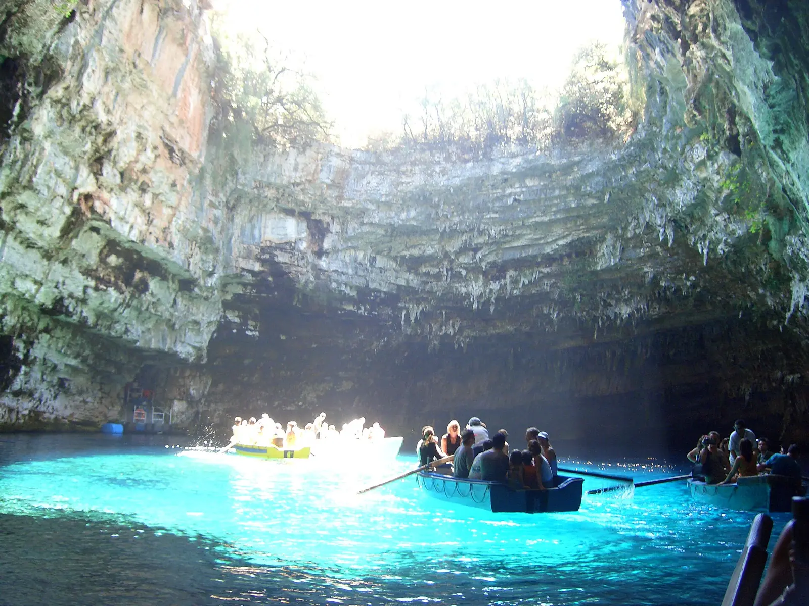 Turquoise underground lake with limestone walls inside Melissani Cave, Kefalonia